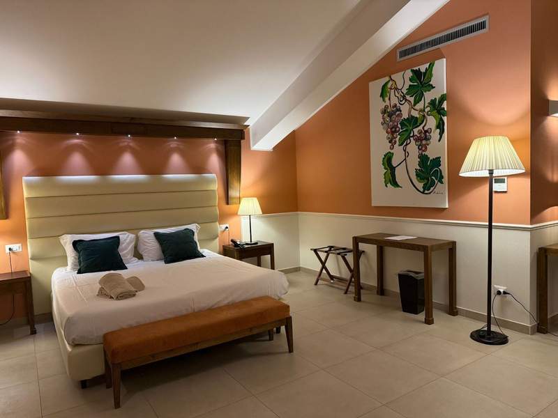 A king-sized bed in one of the guest rooms at Baglio Soria Firriato Wine Resort.