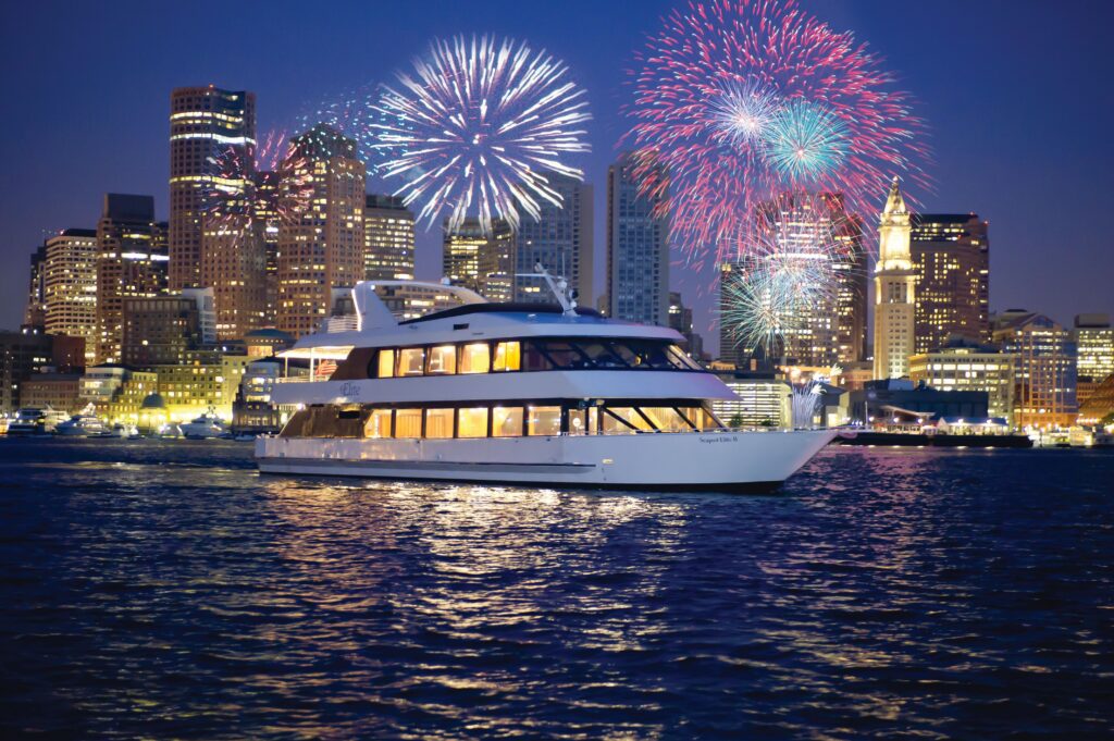 City Cruise ship in the water at night overlooking a city skyline with fireworks