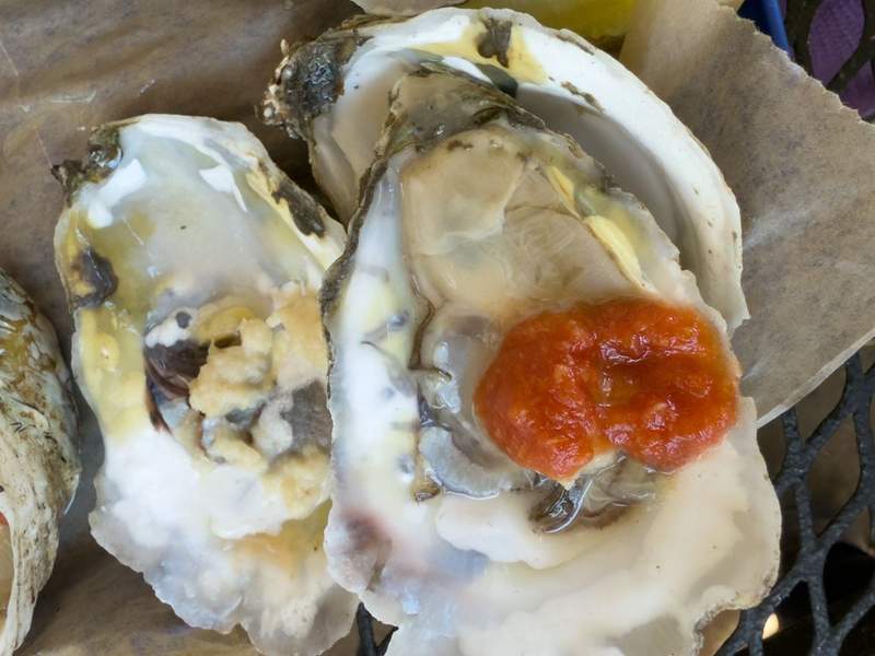 Close-up of chilled half-shell oysters with lemon wedges at Ocracoke Oyster Company in the Outer Banks.
