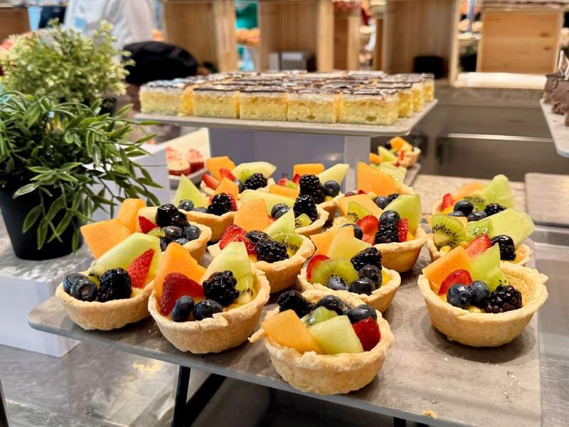 Colorful fruit tarts in a flaky crust offered at the buffet.