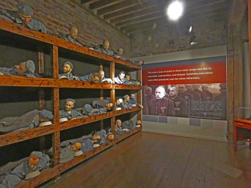 Exhibit of many men packed tightly it bunks.