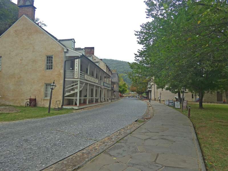 narrow street with historic building lining it and cobblestone walkways.