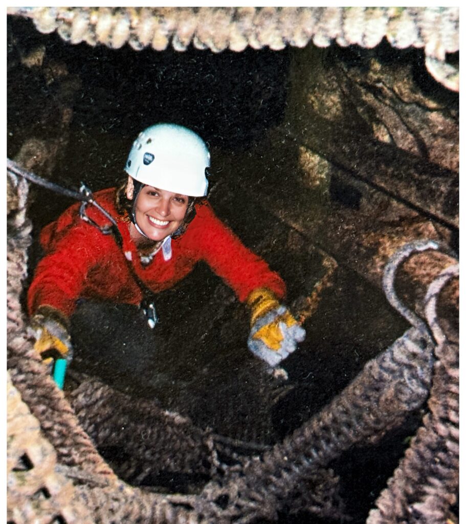 Woman climbing in a hollow tree
