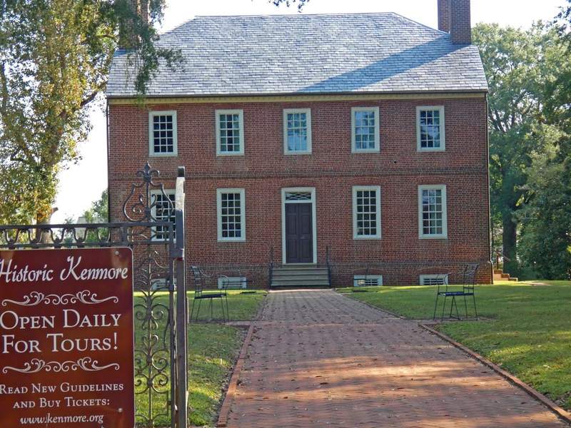 Red brick building with sign n front saying