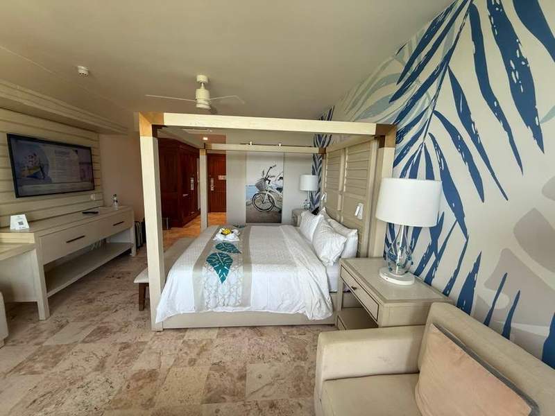 Resort hotel room with brown marble floors and blue and brown tropical decor