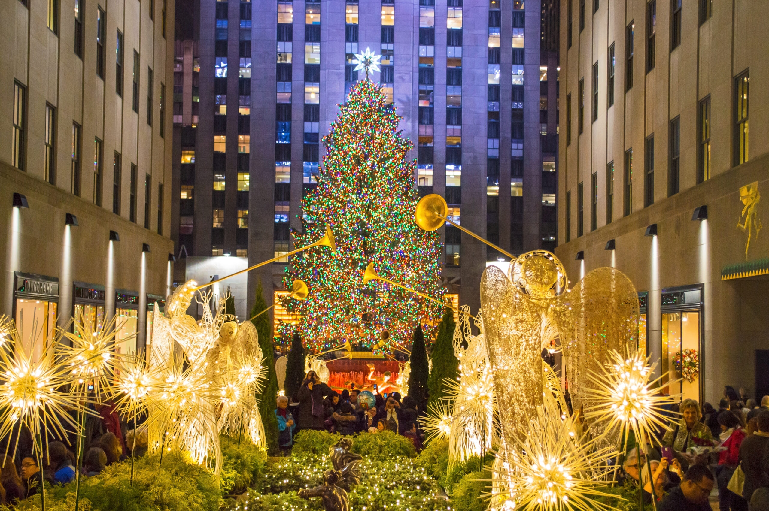 Illuminated angel sculptures in front of the Rockefeller Center tree at Christmas in NYC