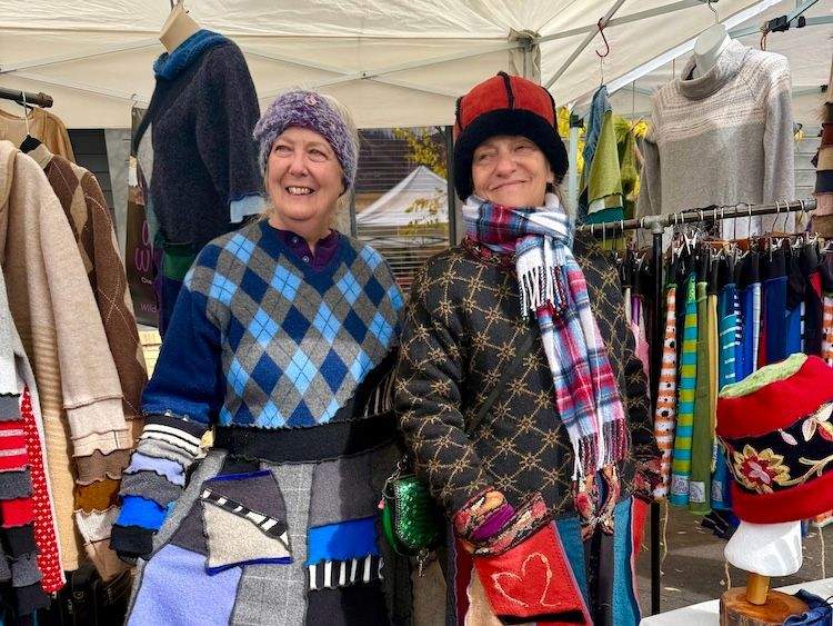 Two women vendors wear vibrant, upcycled wool clothing at the Happy Trails Festival in Ketchum.