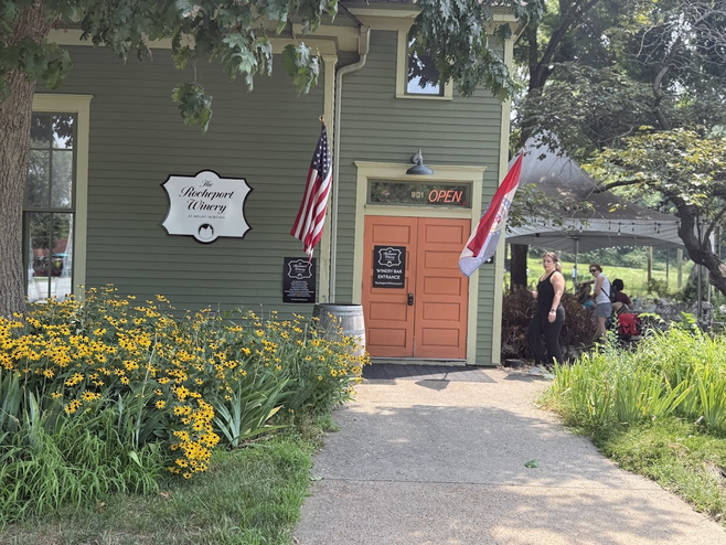 Historic buildings near the Katy Trail are adorned with flowers and many people outside in Rocheport, Missouri.