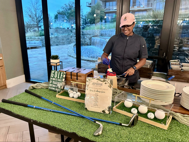 Chef in golf attire preps omelets at The Apron Kitchen + Bar at the Omni PGA Resort in Frisco, Texas.
