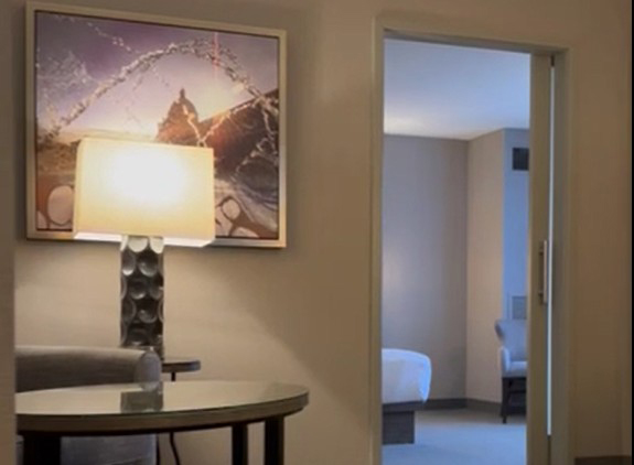 Table and lamp outside the entrance to the bedroom in a suite at the Hyatt Regency in Boston.