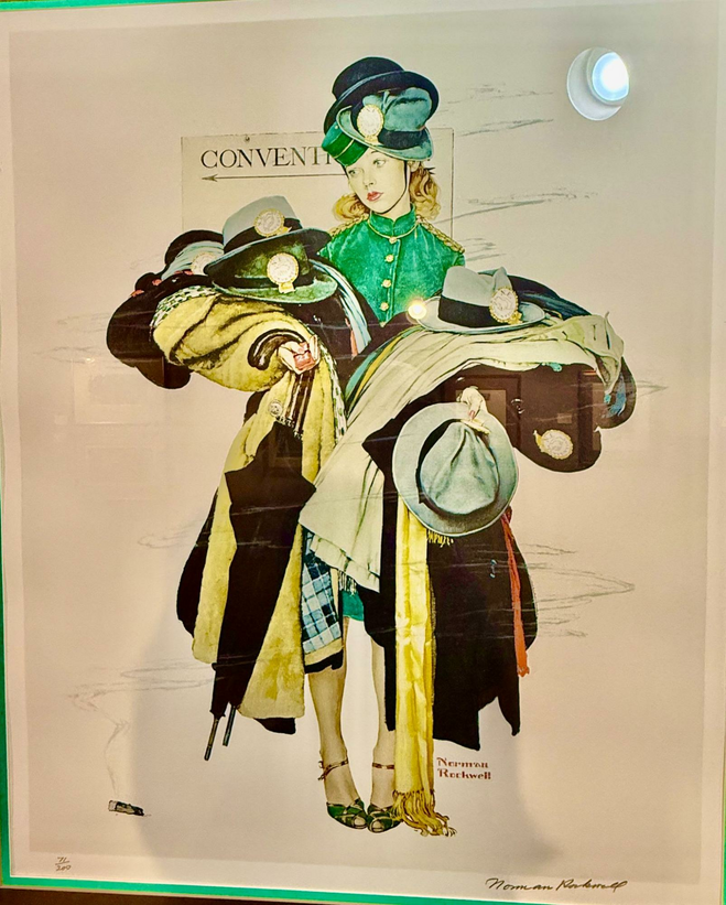 The hatcheck girl in Norman Rockwell's painting can barely hold all the coats and hats piled on each of her arms, plus extra hats stacked on her head. Her face looks wistful but determined.