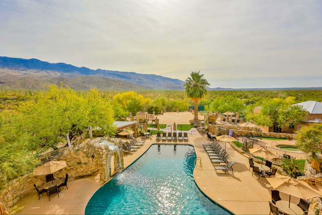 The pool at Tanque Verde Ranch surrounded by the mountainous desert landscape.