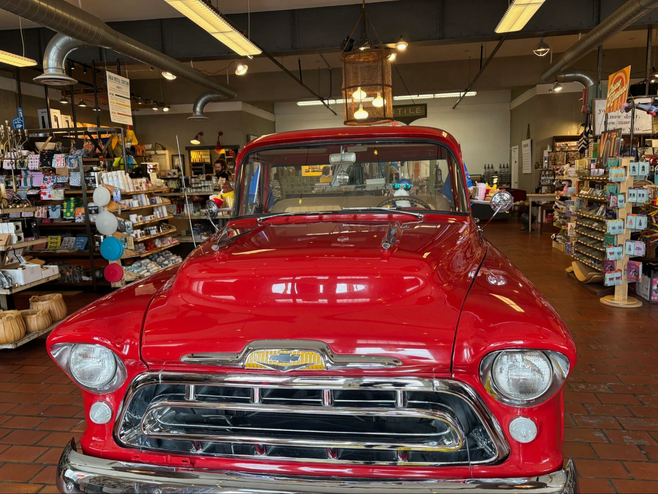 Red vintage care as part of a display in an old hardware and five-and-dime store