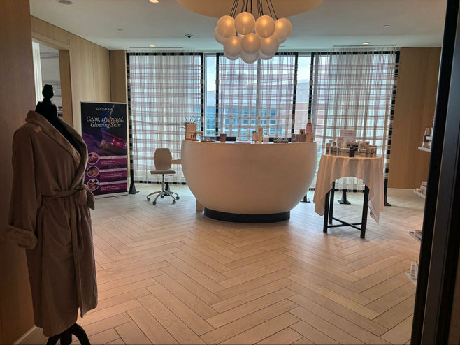 Entry into a spa with views of the skyline behind a welcome desk
