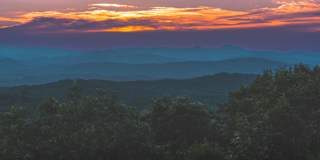 Catch the sun as it sets over the mountains of North Carolina from Jump Off Rock in Hendersonville.