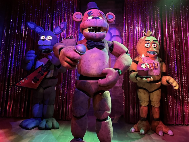 Large animatronic puppets performing music on stage