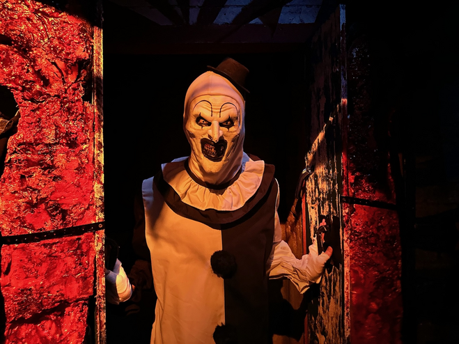 Clown with black and white makeup in a haunted house