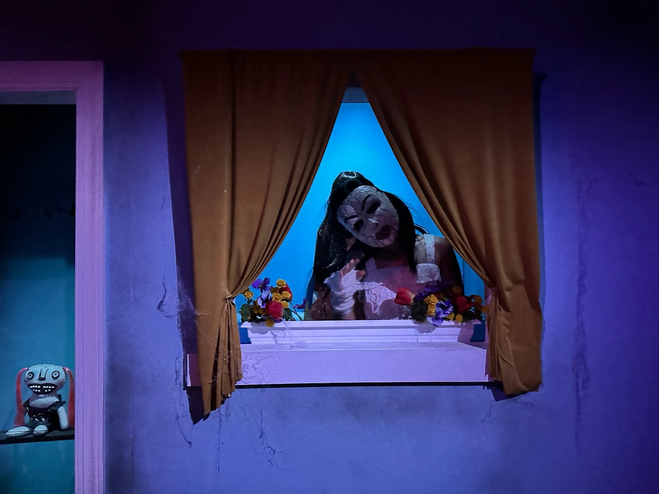 Girl with scary mask in a haunted house.