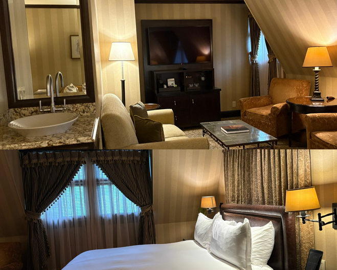 A tan bedroom with a white king-sized bed and side lamps on the wall at The American Club.A living room with two brown chairs, a cream couch, TV and sink.